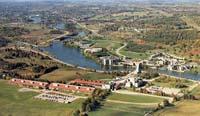 Aerial photograph of land and buildings with a river running through it