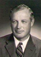 Black and white photograph of a man in a suit